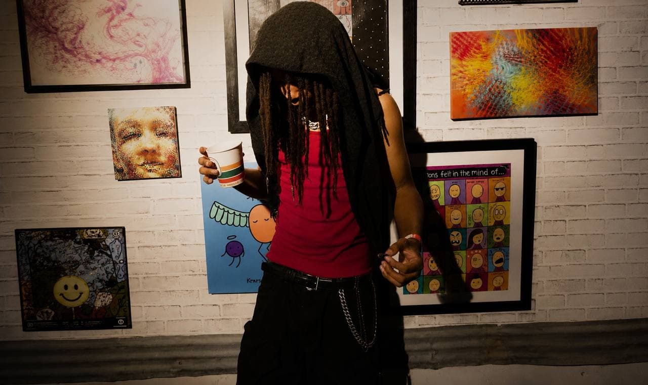 Rene Laveau pictured among framed artwork.